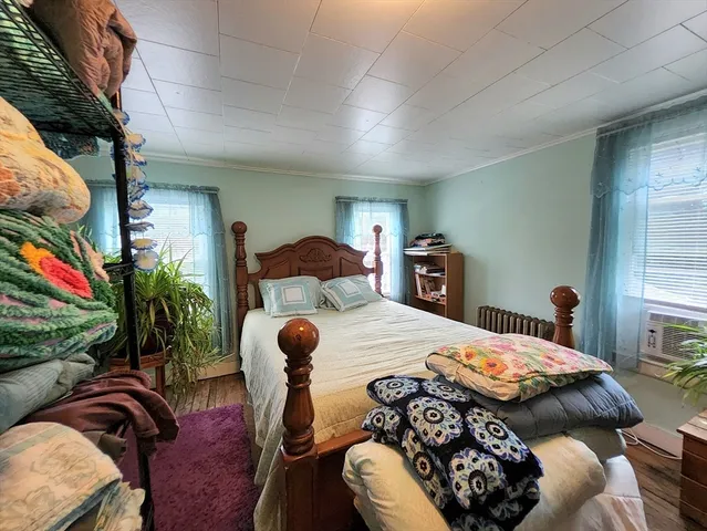 a bedroom with furniture and a flat screen tv