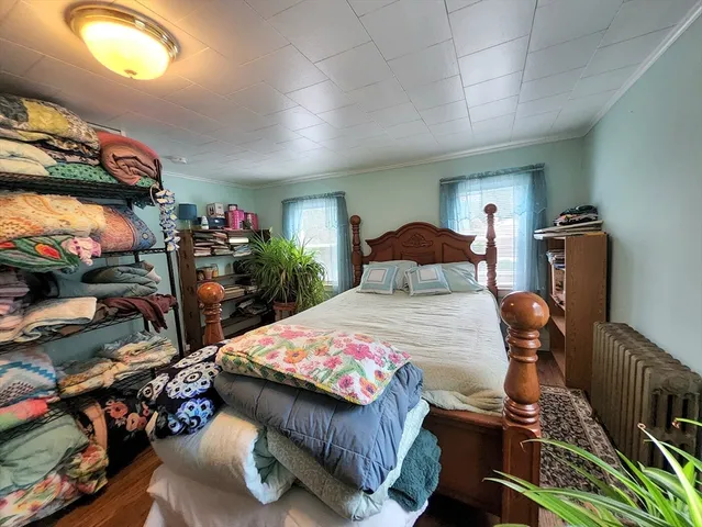 a bedroom with a bed and a tv