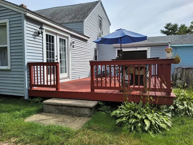 a view of a deck with a table and chairs under an umbrella