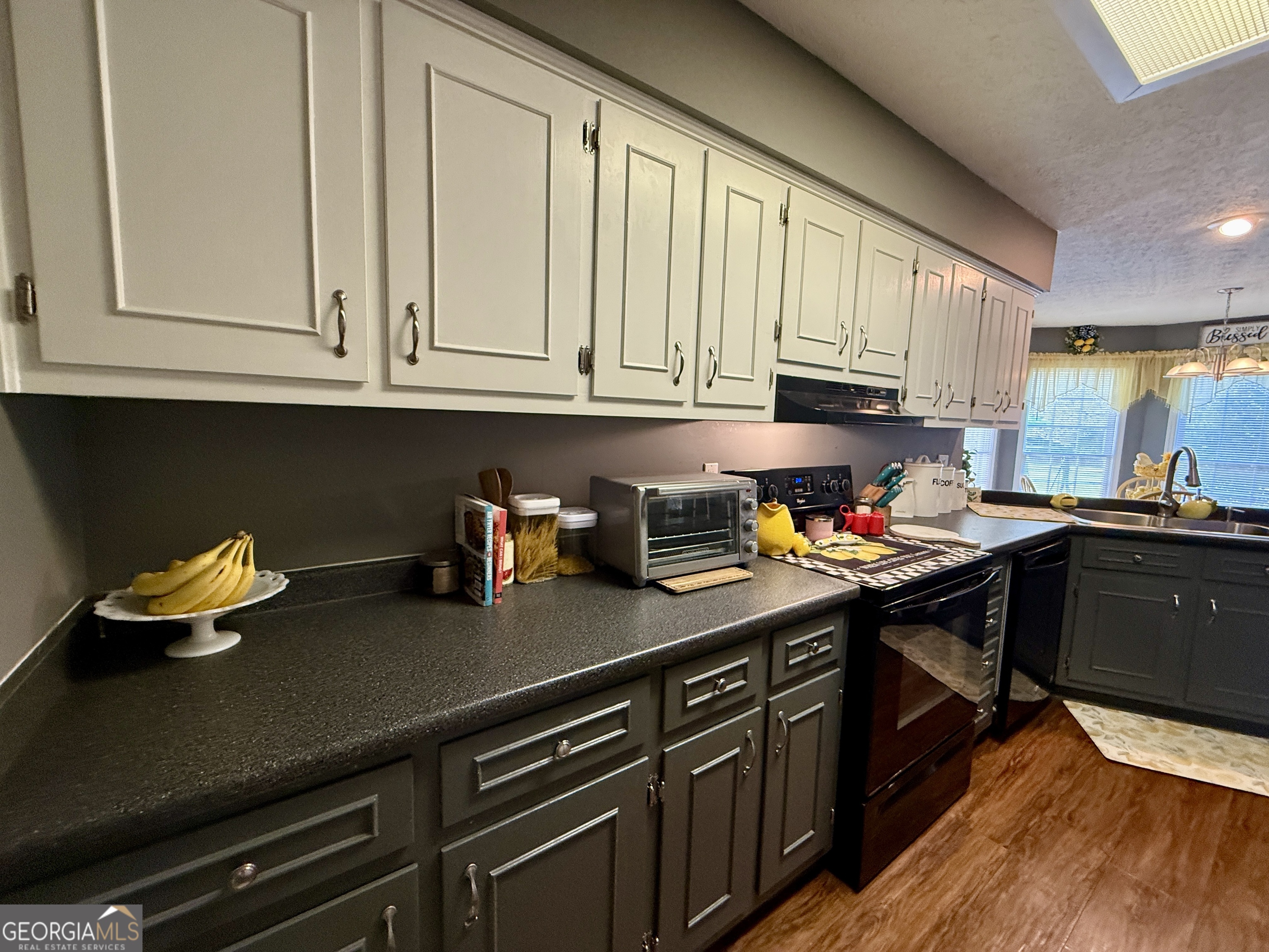 104 Monte Place Cordele, GA 31015 - Photo 11 of 52 a kitchen with stainless steel appliances granite countertop a sink dishwasher stove and cabinets