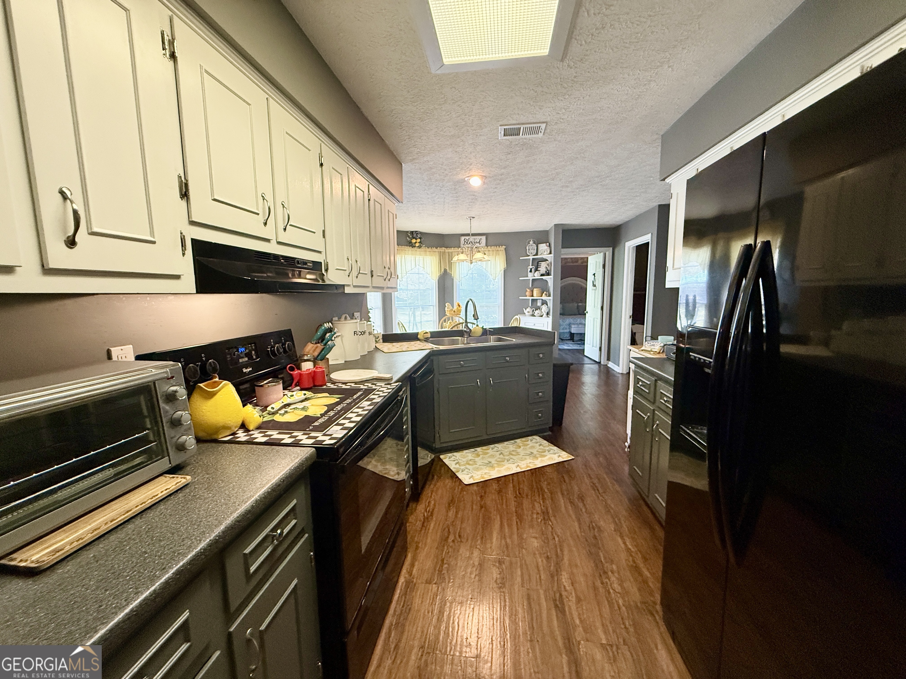 104 Monte Place Cordele, GA 31015 - Photo 12 of 52 a kitchen with stainless steel appliances a stove refrigerator sink and cabinets