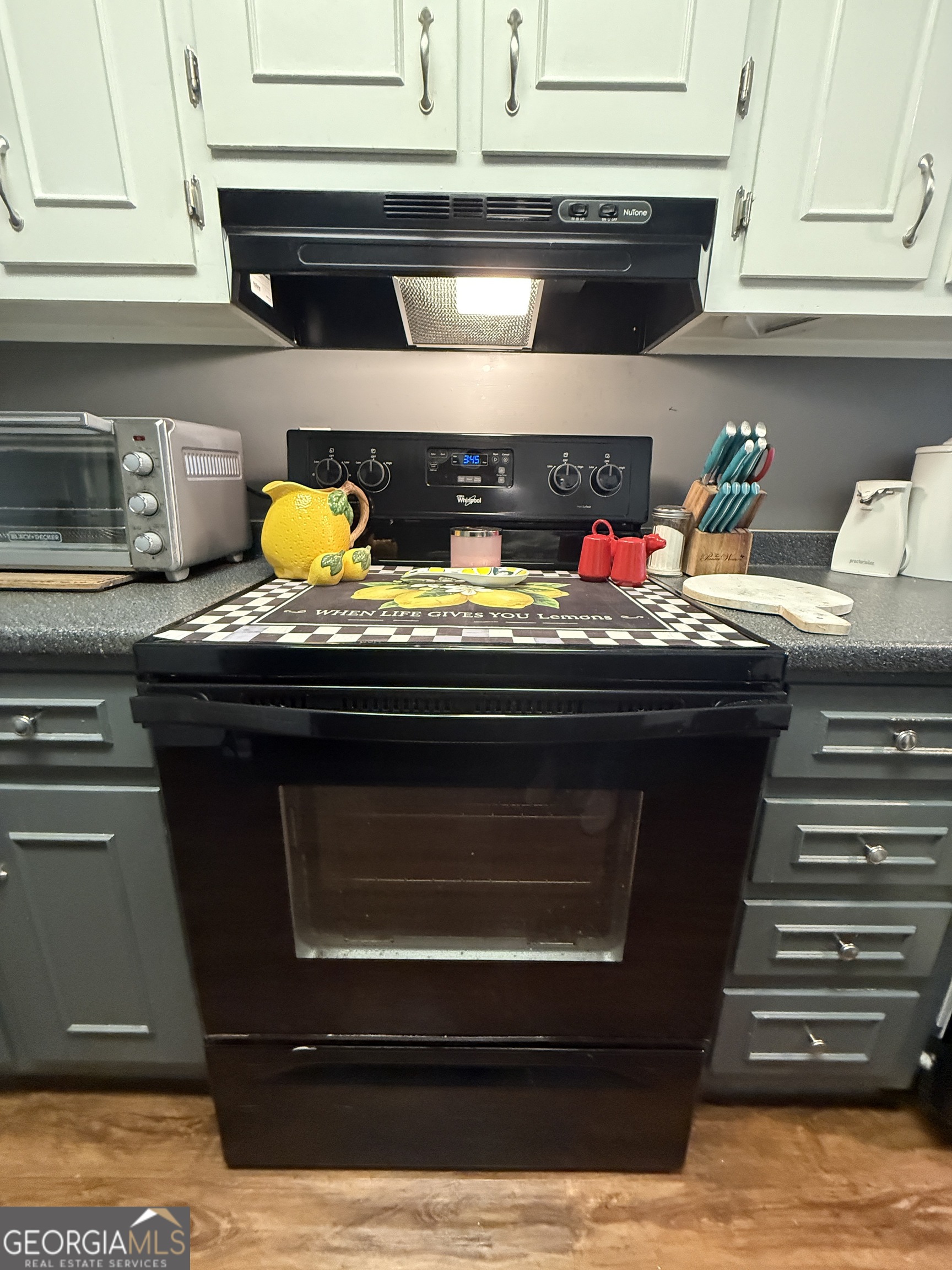 104 Monte Place Cordele, GA 31015 - Photo 14 of 52 a kitchen with stainless steel appliances granite countertop a stove and a microwave