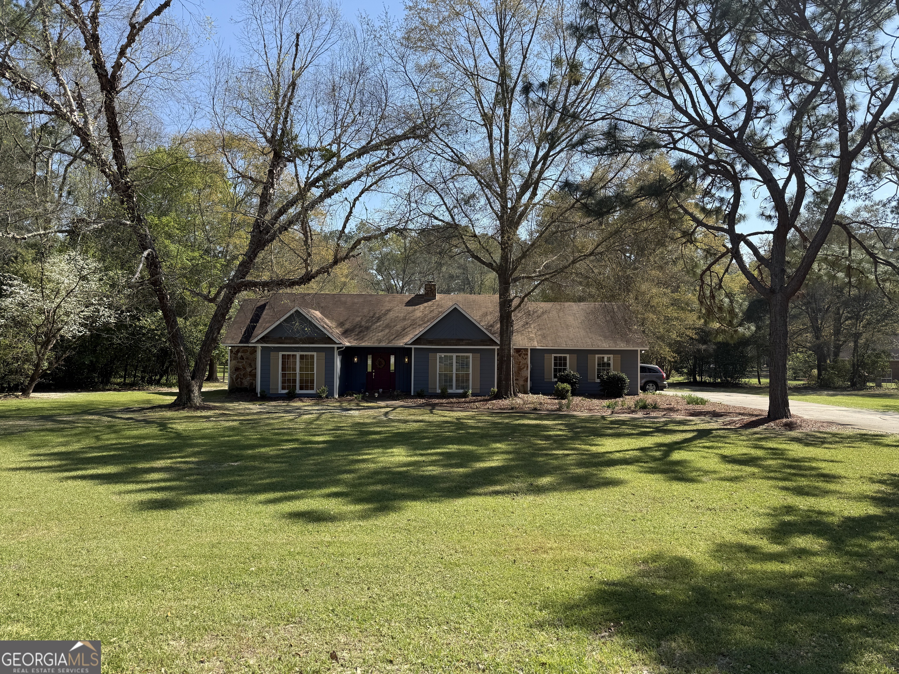 104 Monte Place Cordele, GA 31015 - Photo 2 of 52 a house with a big yard and large trees