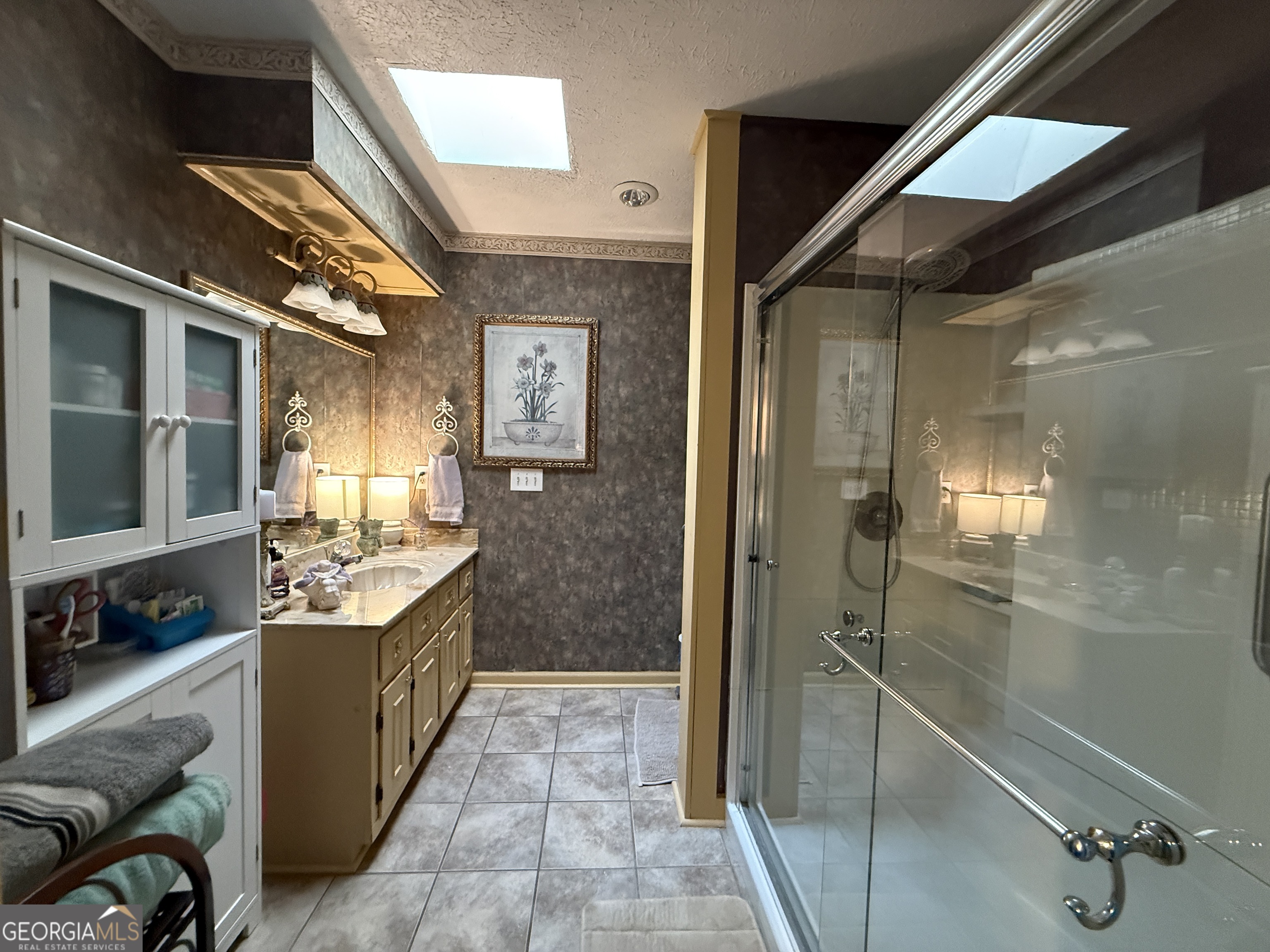 104 Monte Place Cordele, GA 31015 - Photo 26 of 52 a bathroom with a granite countertop sink a mirror and shower