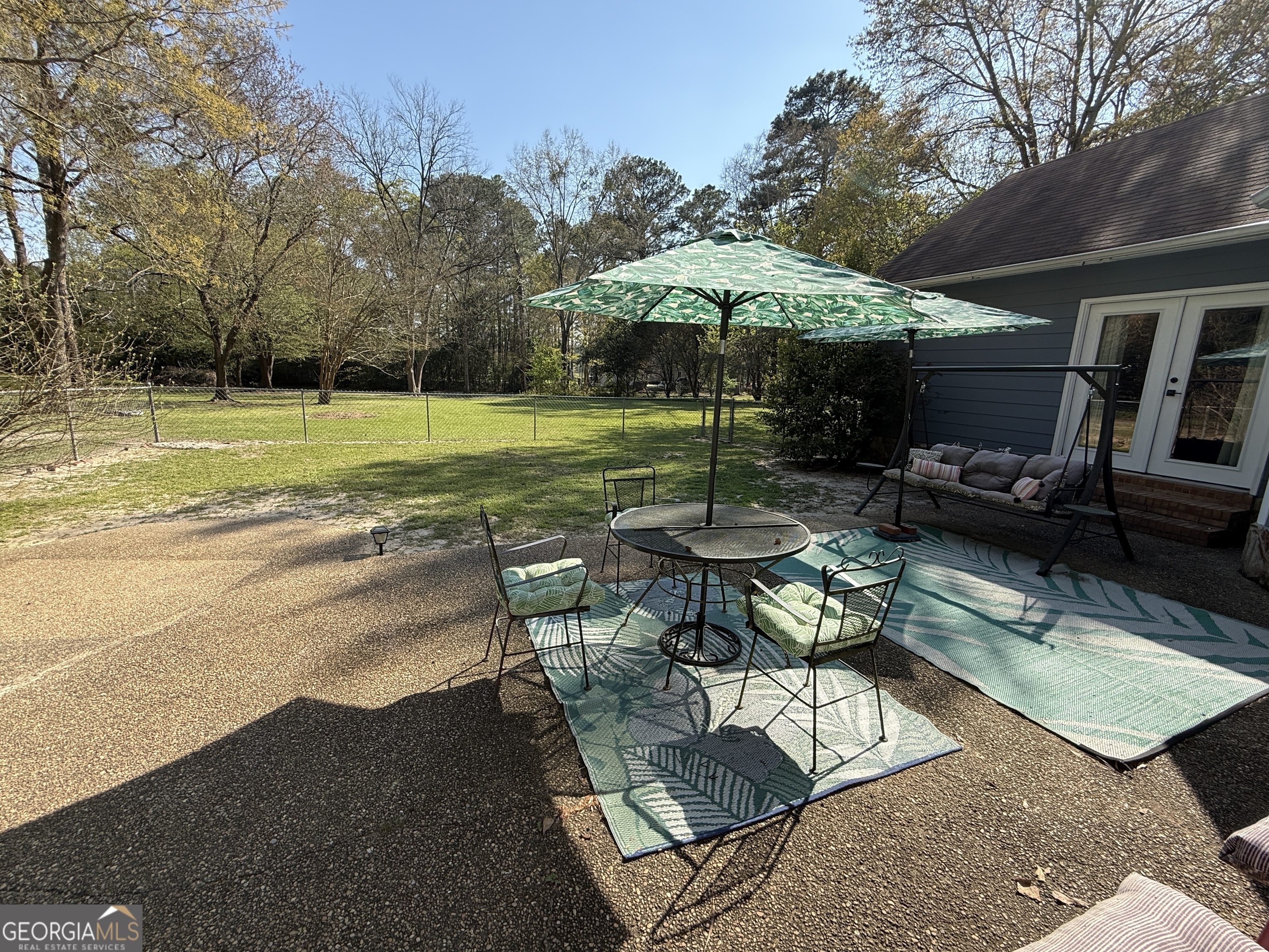 104 Monte Place Cordele, GA 31015 - Photo 46 of 52 a view of a swimming pool with a table and chairs under an umbrella