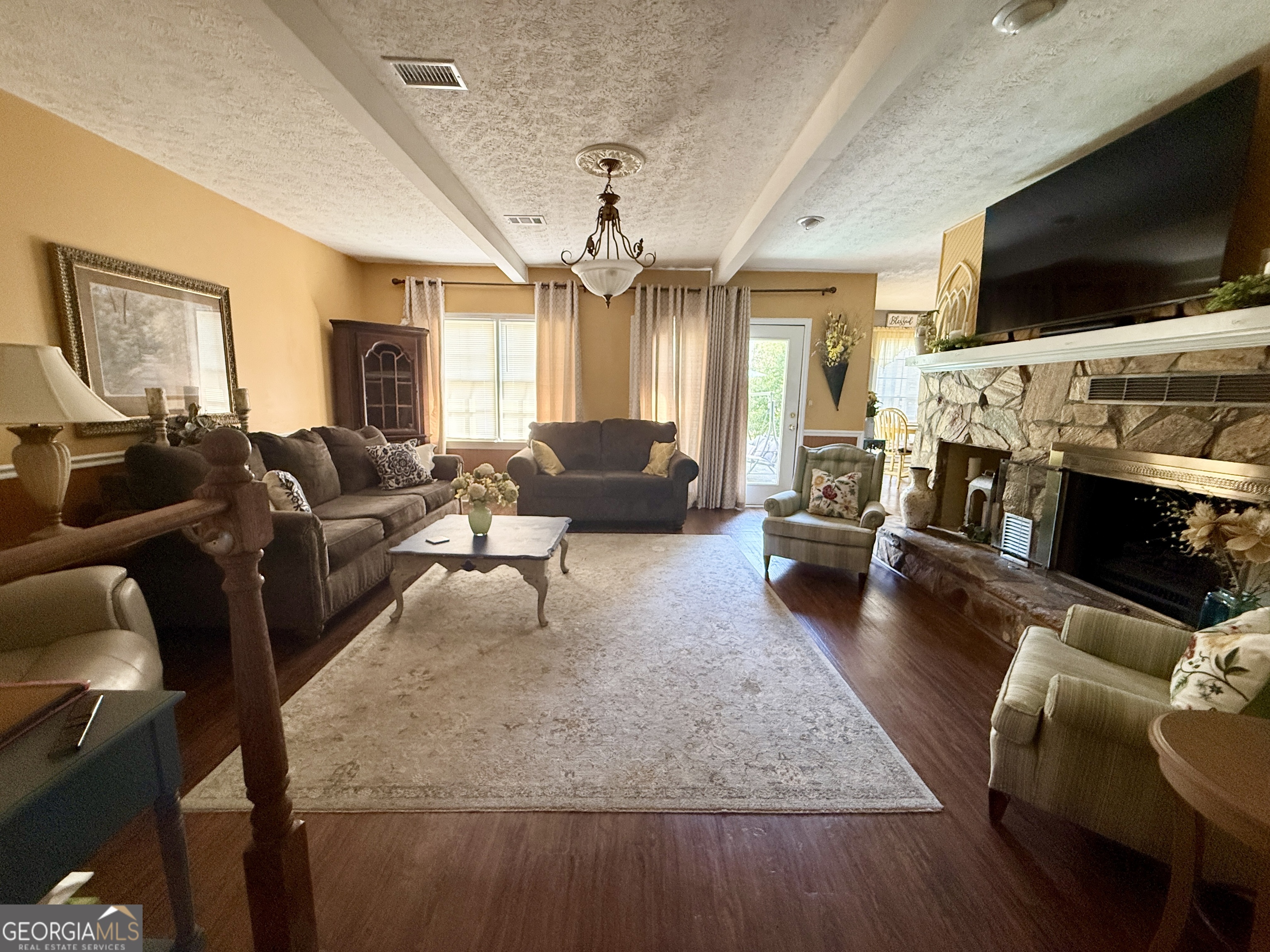 104 Monte Place Cordele, GA 31015 - Photo 7 of 52 a living room with fireplace furniture and a flat screen tv