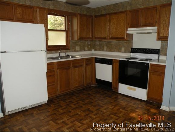 1132 Hoke Loop Road Fayetteville, NC 28314 - Photo 3 of 12 a kitchen with a sink cabinets and appliances
