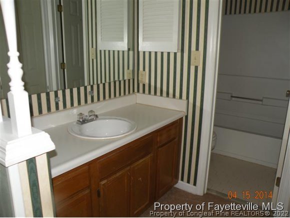 1132 Hoke Loop Road Fayetteville, NC 28314 - Photo 7 of 12 a bathroom with a sink and a mirror