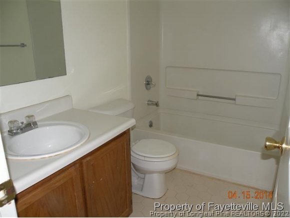1132 Hoke Loop Road Fayetteville, NC 28314 - Photo 8 of 12 a bathroom with a sink a toilet and bathtub