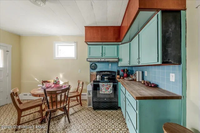 a kitchen with stainless steel appliances kitchen island granite countertop a stove a sink and a microwave
