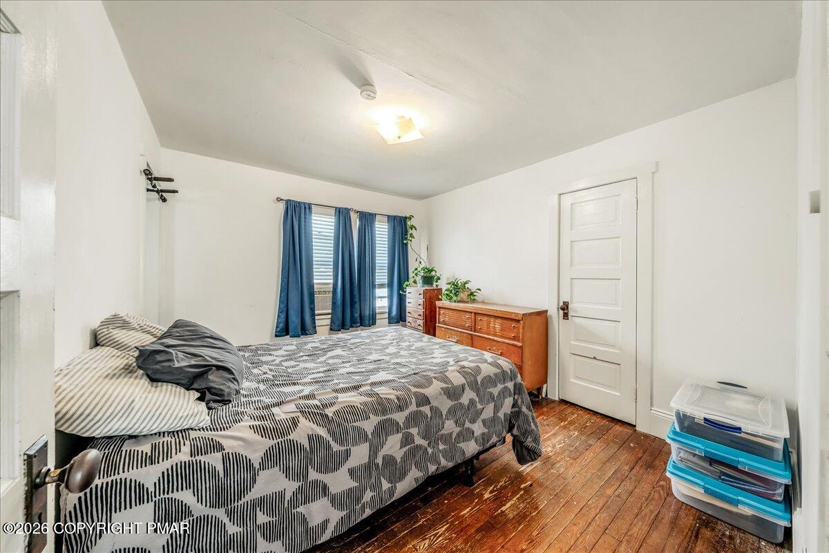 136 St George Street Lewisburg, PA 17837 - Photo 25 of 42 a bedroom with a bed and wooden floor