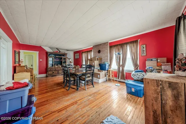 a dining room with furniture and wooden floor