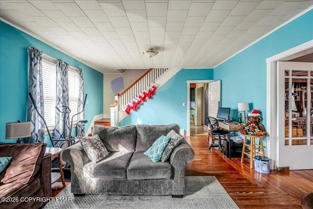 a living room with furniture and a chandelier