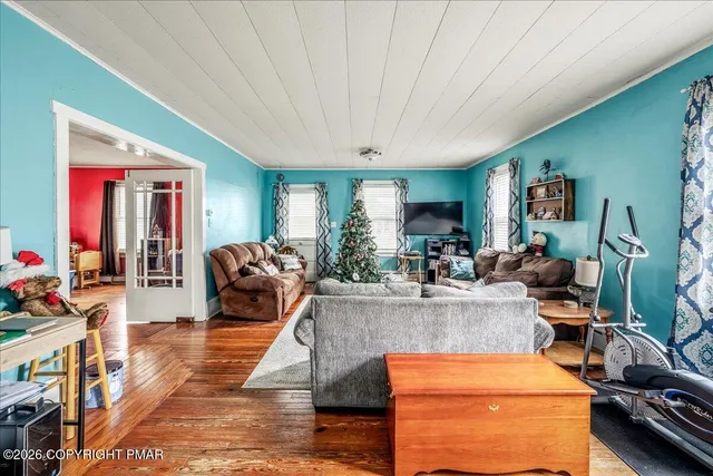 a living room with furniture a window and gym equipment