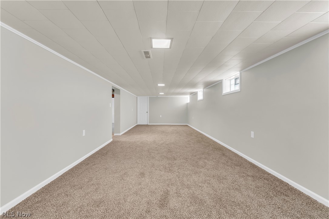 3023 Norris Avenue Cleveland, OH 44134 - Photo 30 of 41 Spacious lower-level room featuring light gray walls, white trim, and neutral-toned carpeting