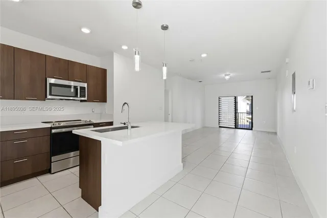 a kitchen with a sink appliances and cabinets