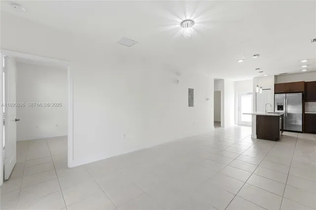 a view of a kitchen with a sink and a refrigerator