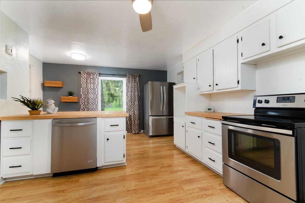 246 Forsythe Road Valencia, PA 16059 - Photo 11 of 23 a kitchen with white cabinets and stainless steel appliances