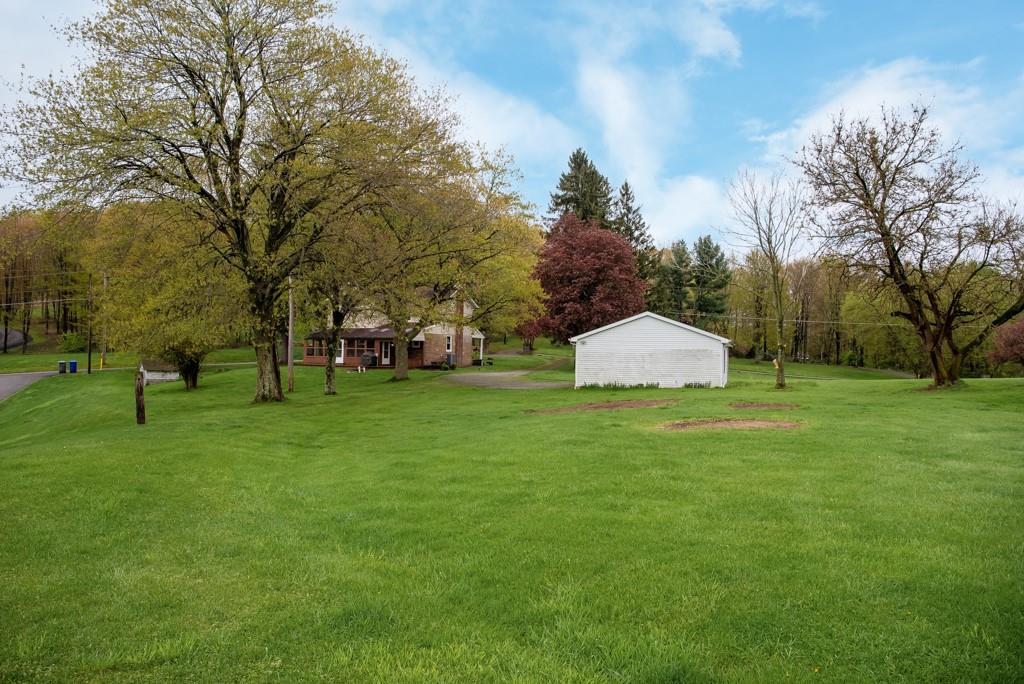 246 Forsythe Road Valencia, PA 16059 - Photo 23 of 23 a backyard of a house with plants and large tree
