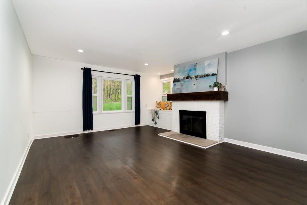 246 Forsythe Road Valencia, PA 16059 - Photo 7 of 23 a view of an empty room with wooden floor fireplace and a window