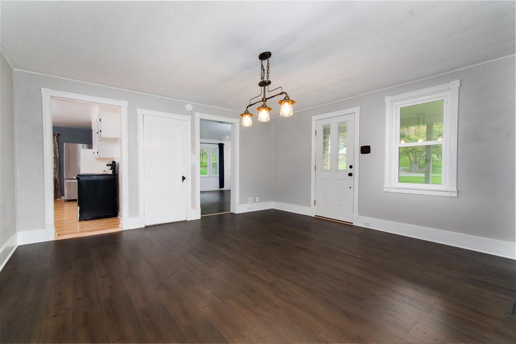 246 Forsythe Road Valencia, PA 16059 - Photo 9 of 23 an empty room with wooden floor mirror and windows