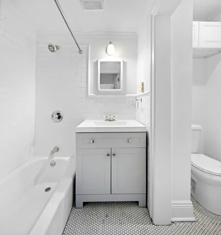 a bathroom with a sink a toilet and bathtub
