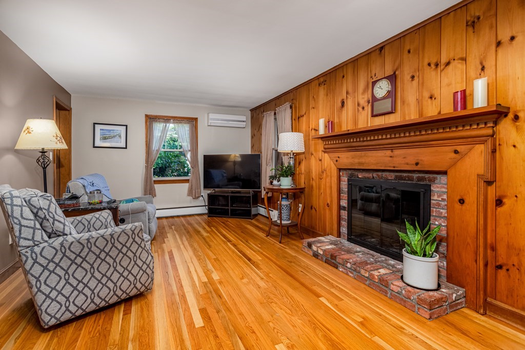 2 Victor Drive Ayer, MA 01432 - Photo 12 of 42 a living room with furniture a fireplace and a flat screen tv