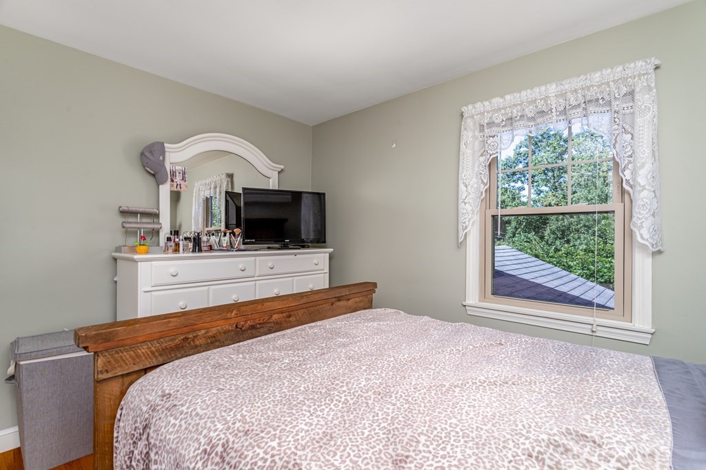 2 Victor Drive Ayer, MA 01432 - Photo 30 of 42 a bedroom with a bed and a flat screen tv