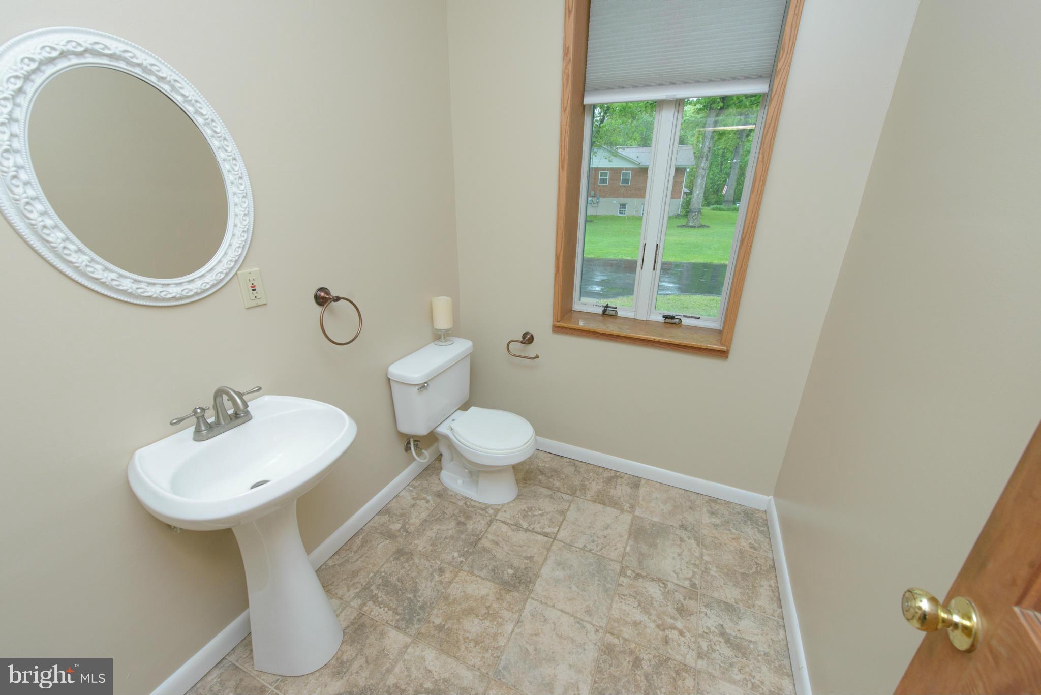 8213 WB&A Road Severn, MD 21144 - Photo 12 of 30 a bathroom with a toilet sink and mirror