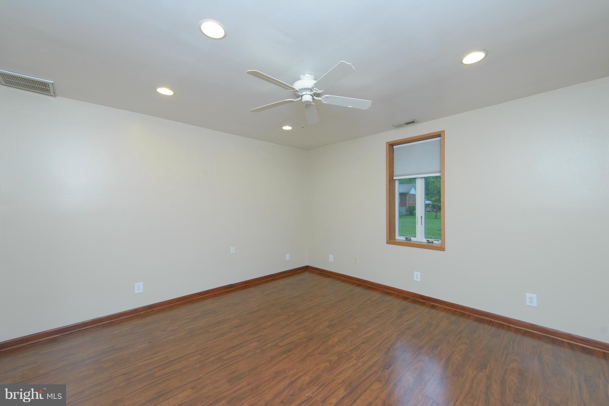 8213 WB&A Road Severn, MD 21144 - Photo 13 of 30 an empty room with a window and a fan