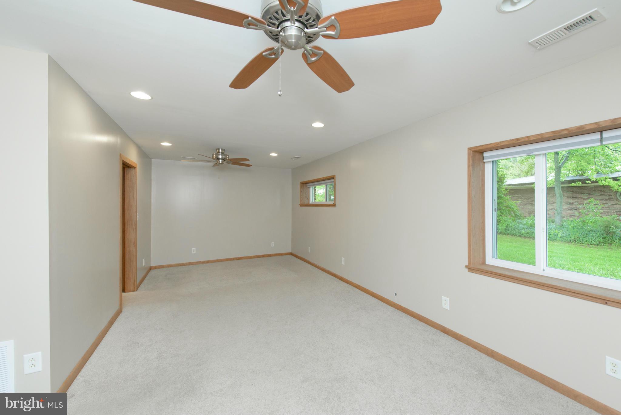8213 WB&A Road Severn, MD 21144 - Photo 14 of 30 en empty room with windows and ceiling fan