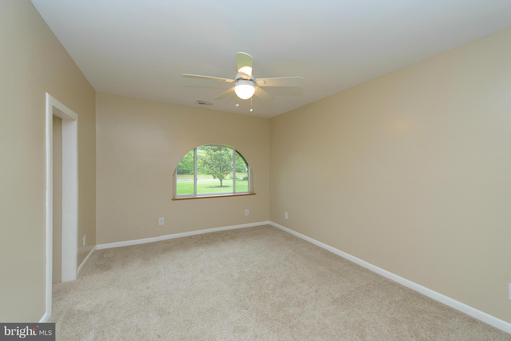 8213 WB&A Road Severn, MD 21144 - Photo 16 of 30 an empty room with a window and a fan