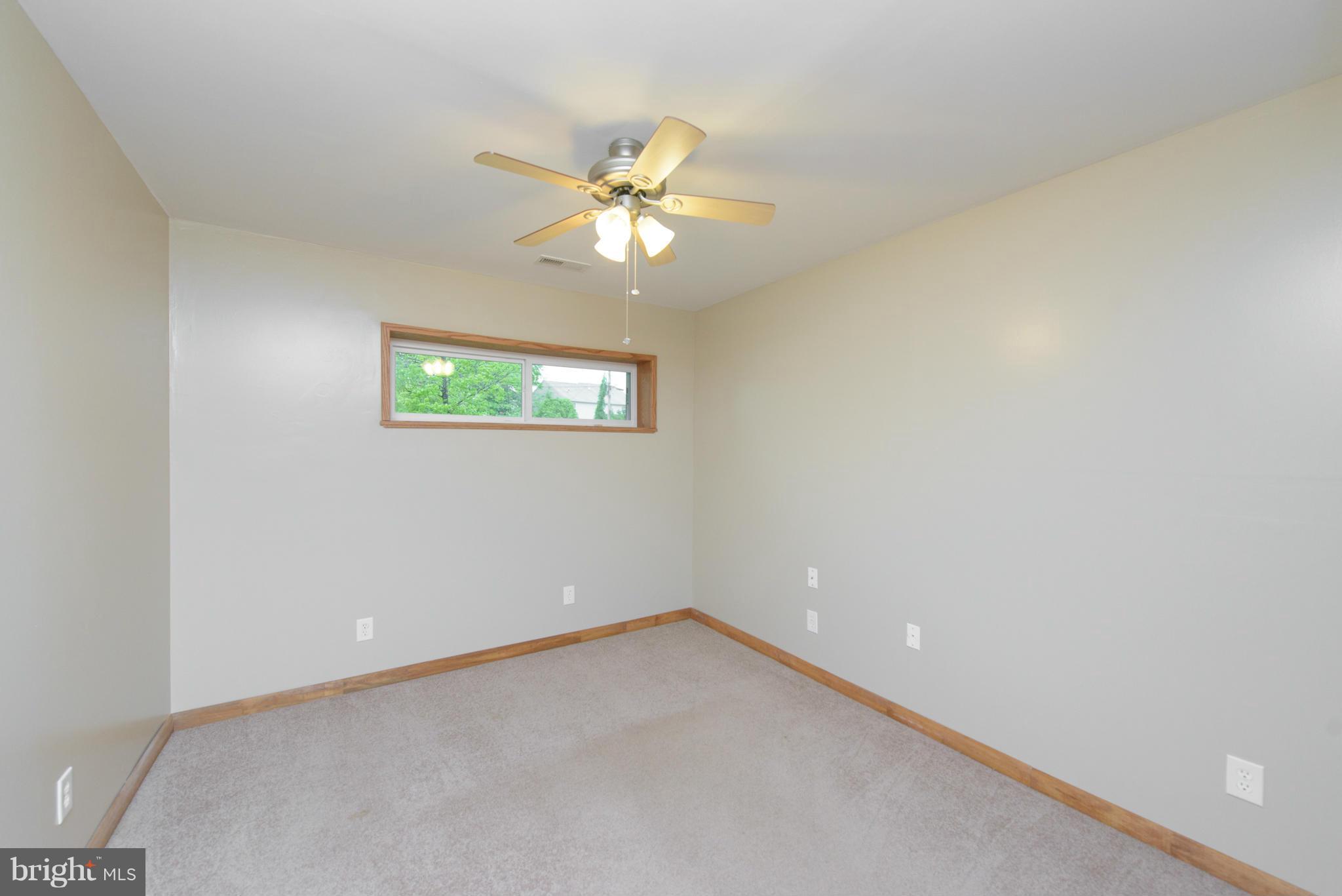 8213 WB&A Road Severn, MD 21144 - Photo 18 of 30 an empty room with a window and a fan