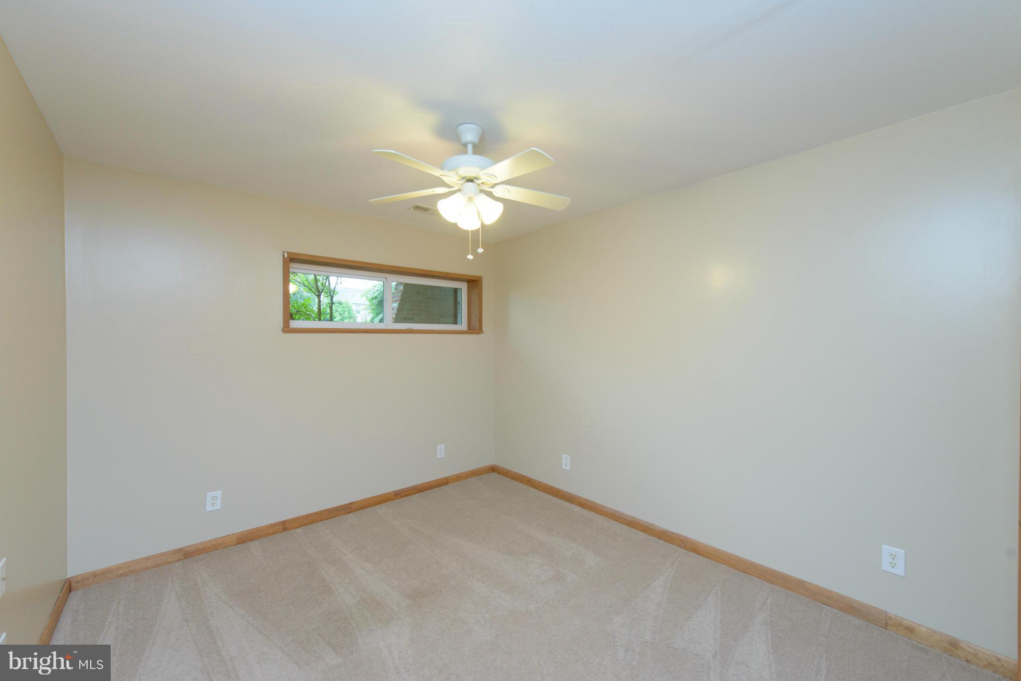 8213 WB&A Road Severn, MD 21144 - Photo 20 of 30 an empty room with a window and a fan