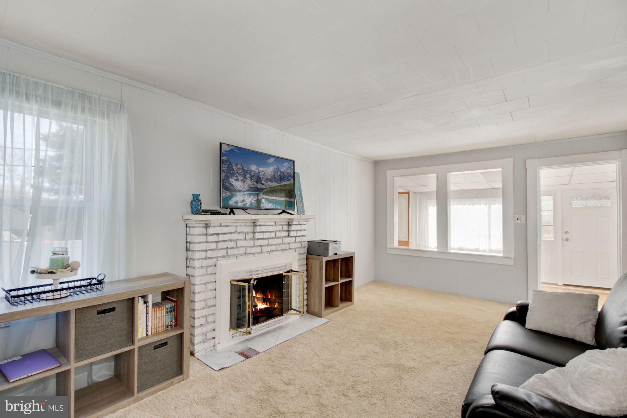 228 Arundel Road Pasadena, MD 21122 - Photo 7 of 32 Wood burning fireplace nestled in the living room