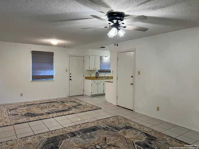 a view of a kitchen with a sink and a refrigerator