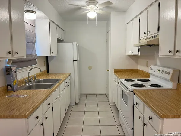 a kitchen with a sink stove and cabinets