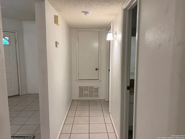 an empty room with a fan