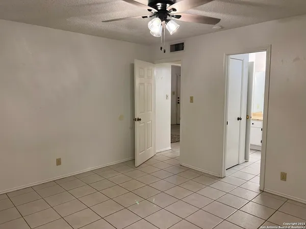 a bathroom with a granite countertop toilet and a sink