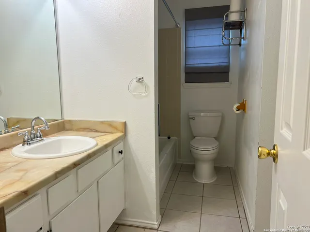 a bathroom with a toilet and a bathtub
