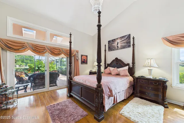 a bedroom with a bed and a chandelier