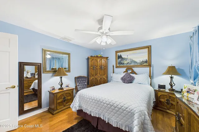 an aerial view of a house with a yard and lake view in back
