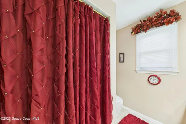 an aerial view of a house with a garden and lake view
