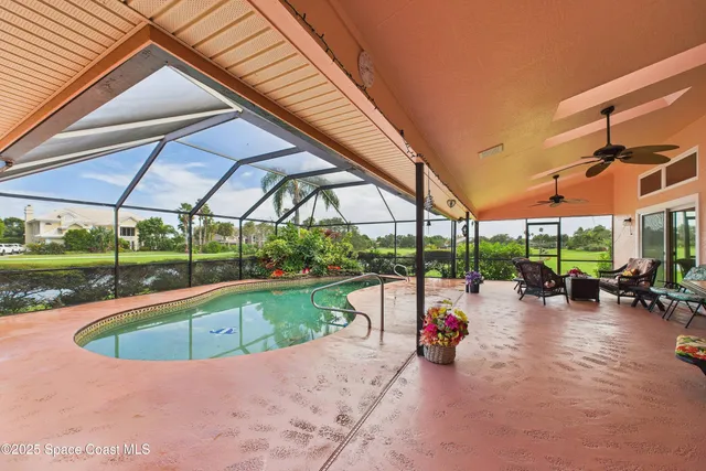 an aerial view of a house with a garden and lake view