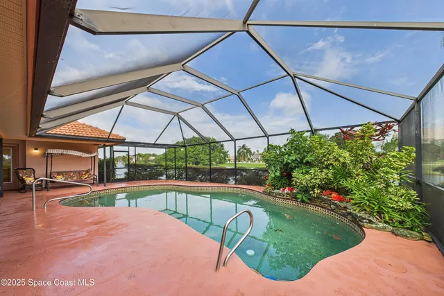 an aerial view of a house with a yard and lake view
