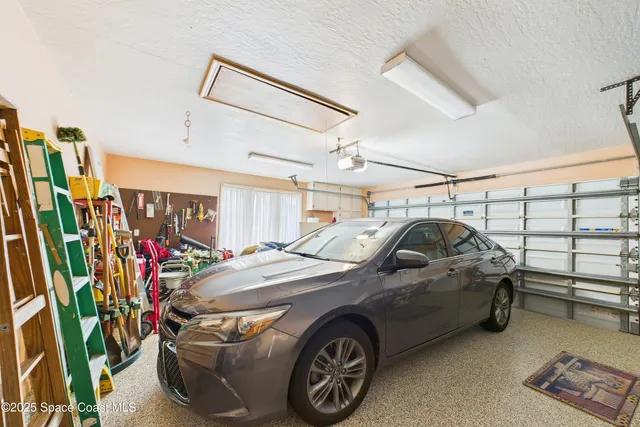 an aerial view of a house with a garden and lake view