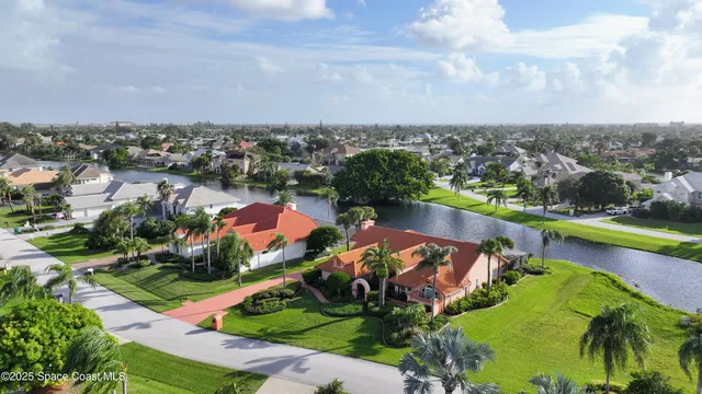 an aerial view of a house with a lake view
