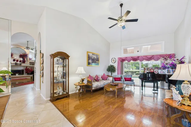 a view of a dining room with furniture and a chandelier