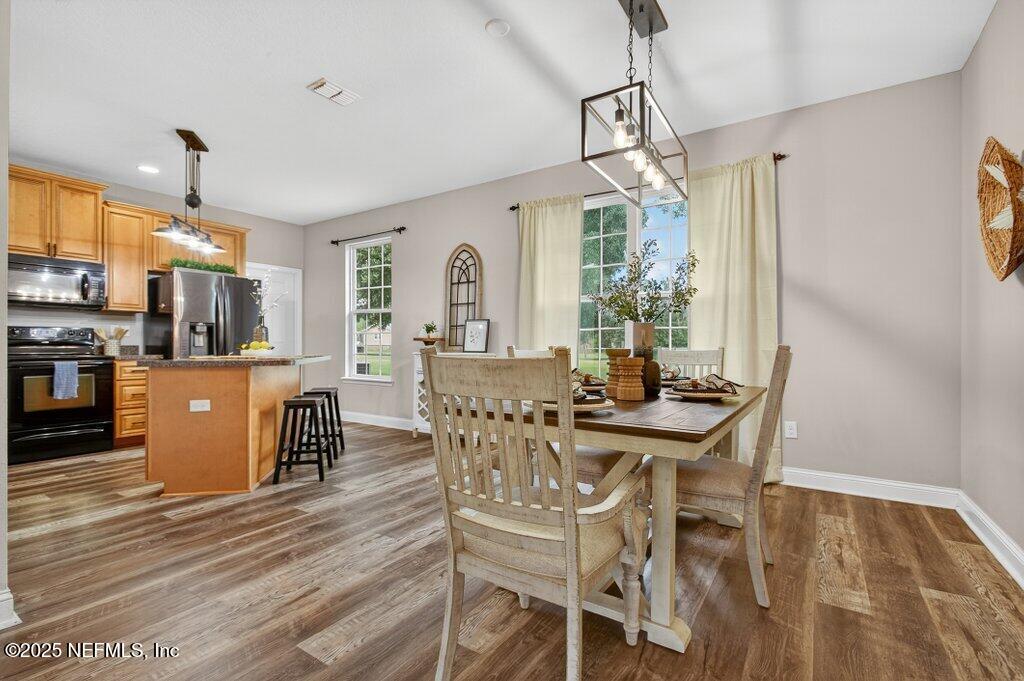 204 Comer Road Palatka, FL 32177 - Photo 12 of 61 a view of a dining room with furniture window and wooden floor
