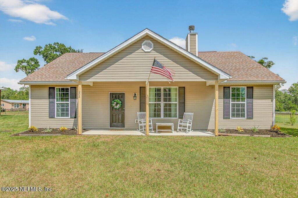 204 Comer Road Palatka, FL 32177 - Photo 2 of 61 a front view of a house with a garden